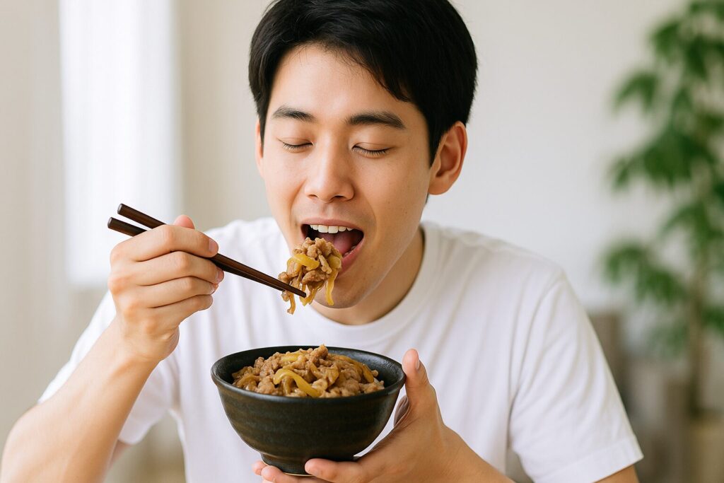 吉野家の株主優待券で牛丼を食べる青年